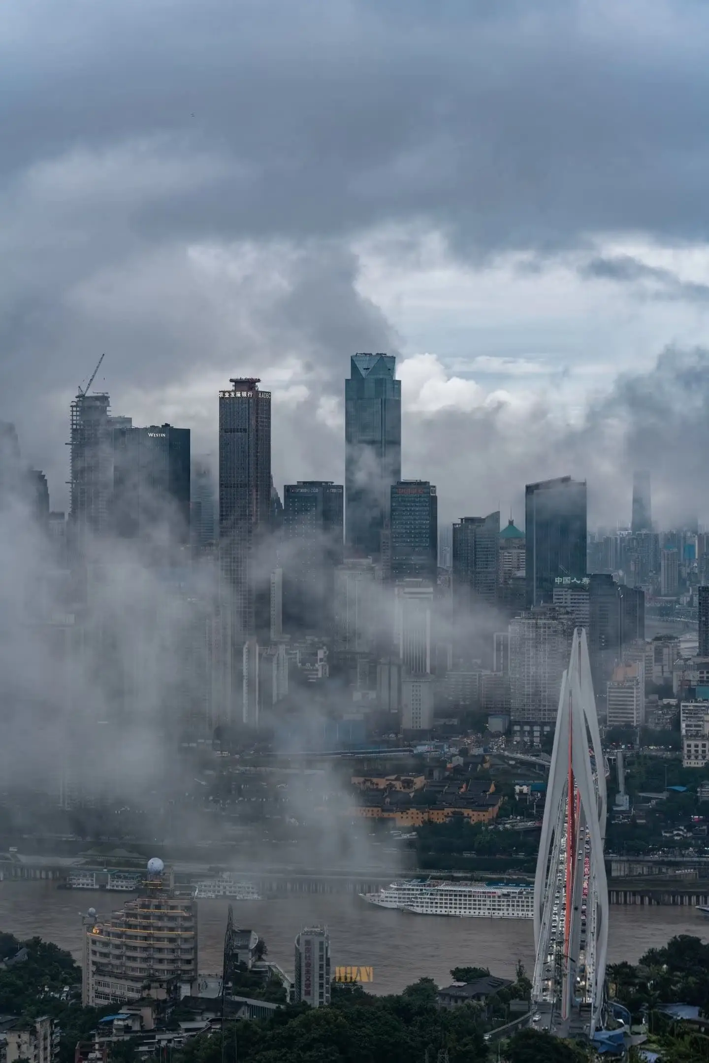 The famous Fog City skyline of Chongqing covered in thick mist during the moody autumn and winter transition.