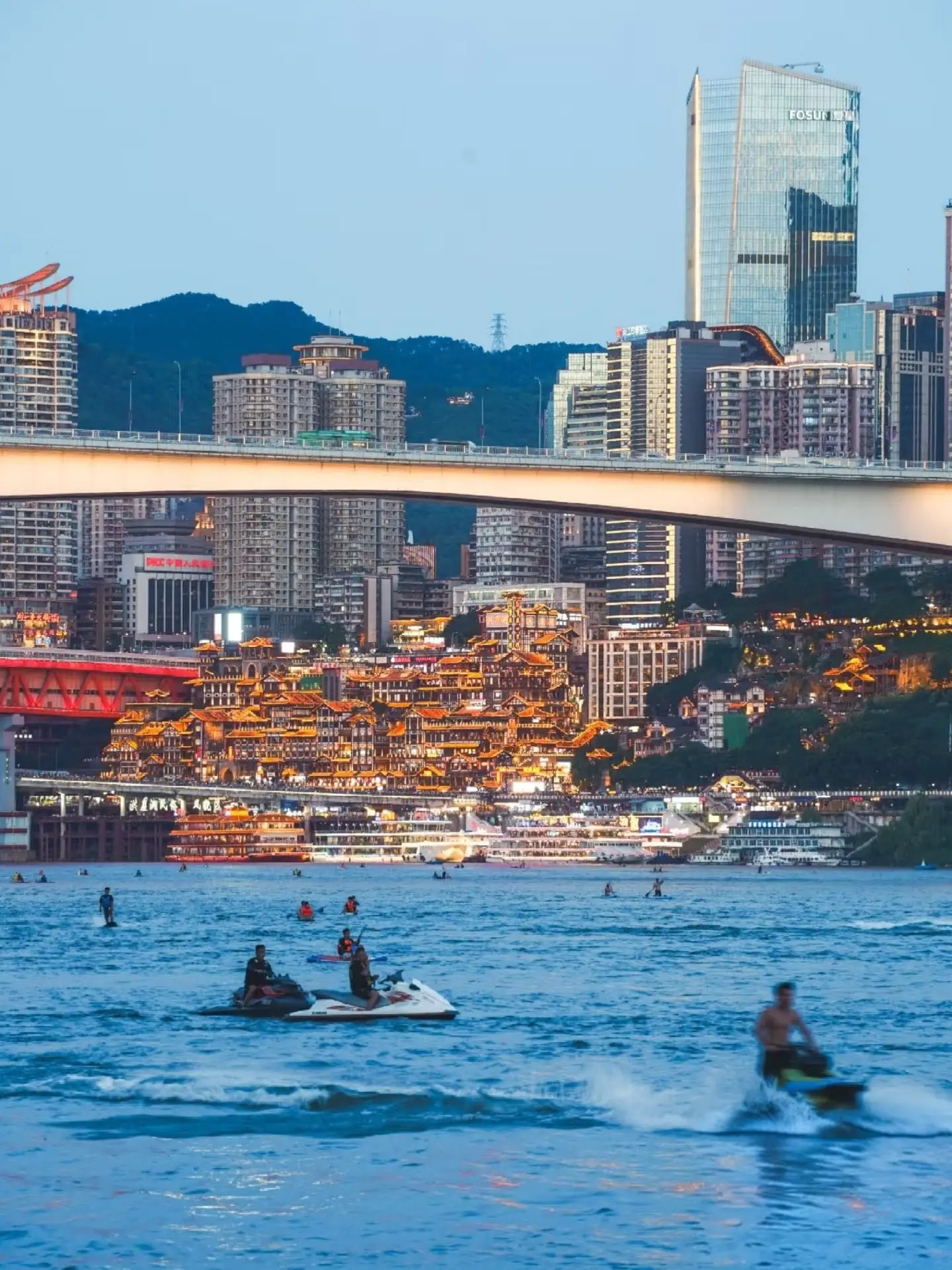 Locals enjoying summer water sports in the Yangtze River. Warning: Wild swimming in Chongqing rivers is extremely dangerous due to hidden currents.